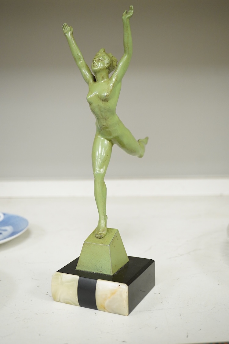 An Art Deco patinated spelter figurine of a nude dancer raised on black and green onyx base, 29cm high